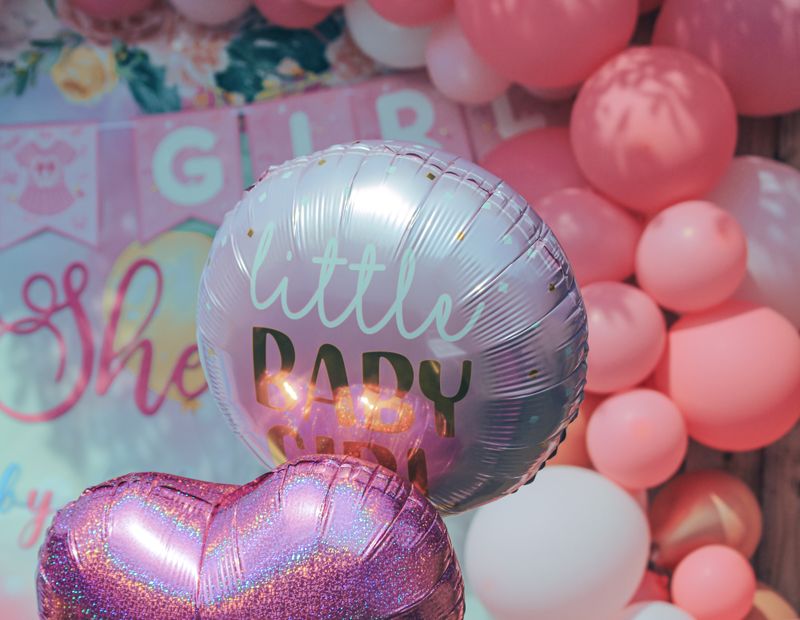 Pink baby shower décor with heart balloons