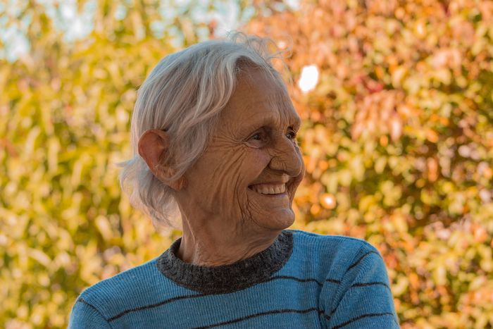 A comforted, smiling elderly woman