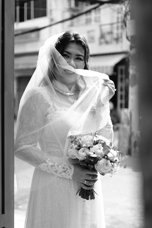 Grayscale Photo of a Bride in Her Wedding Dress