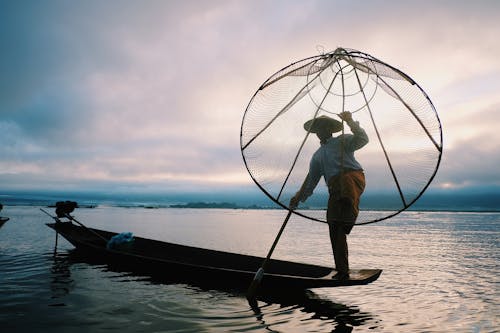 Free A Person Holding a Fish Net Stock Photo