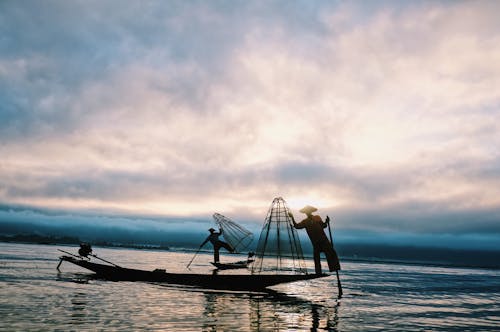 Silhouettes of Fishermen with Fish Nets
