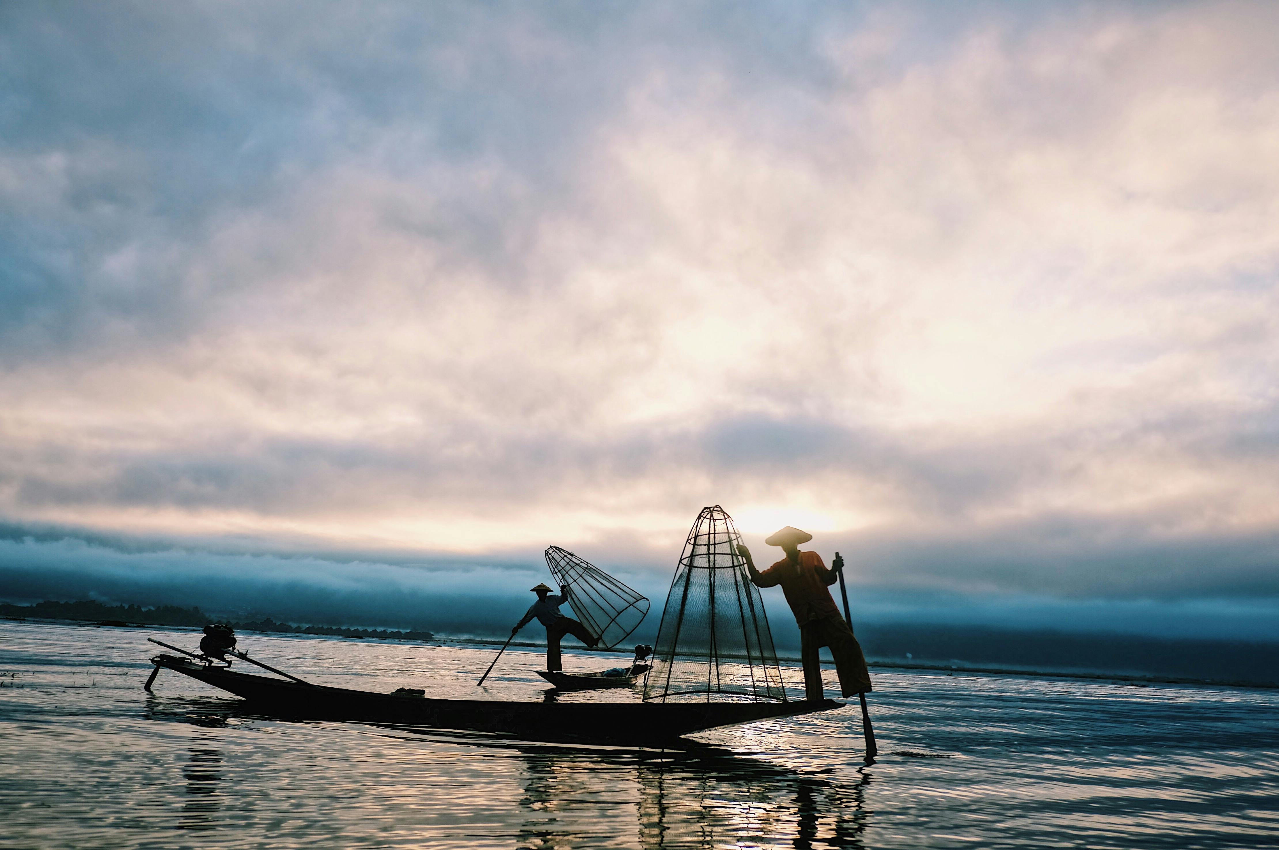 Fisherman repairing his net hi-res stock photography and images