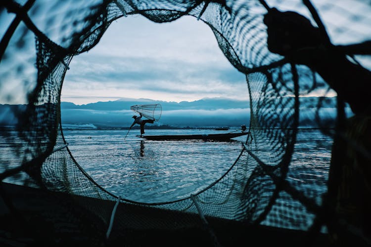 Traditional Fisherman Fishing In A Lake In Asia 