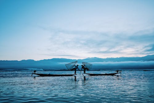 Silhouettes of Fishermen at Sea