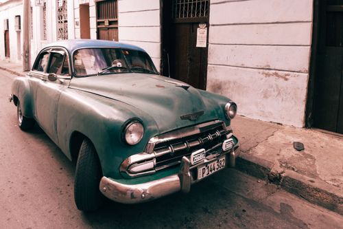 Free Classic vintage Chevrolet car parked on a street, showcasing timeless design and retro charm. Stock Photo