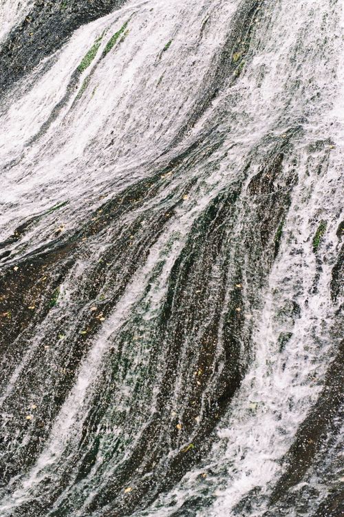 Free Close-up of a powerful waterfall showcasing cascading textures and motion. Stock Photo