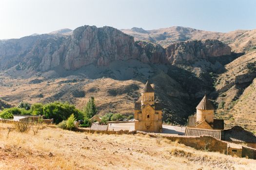 Stunning view of an ancient Armenian monastery nestled in a rugged mountain landscape.