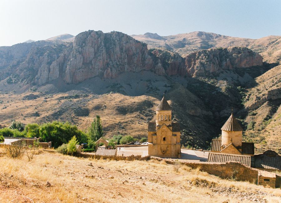 Stunning view of an ancient Armenian monastery nestled in a rugged mountain landscape.