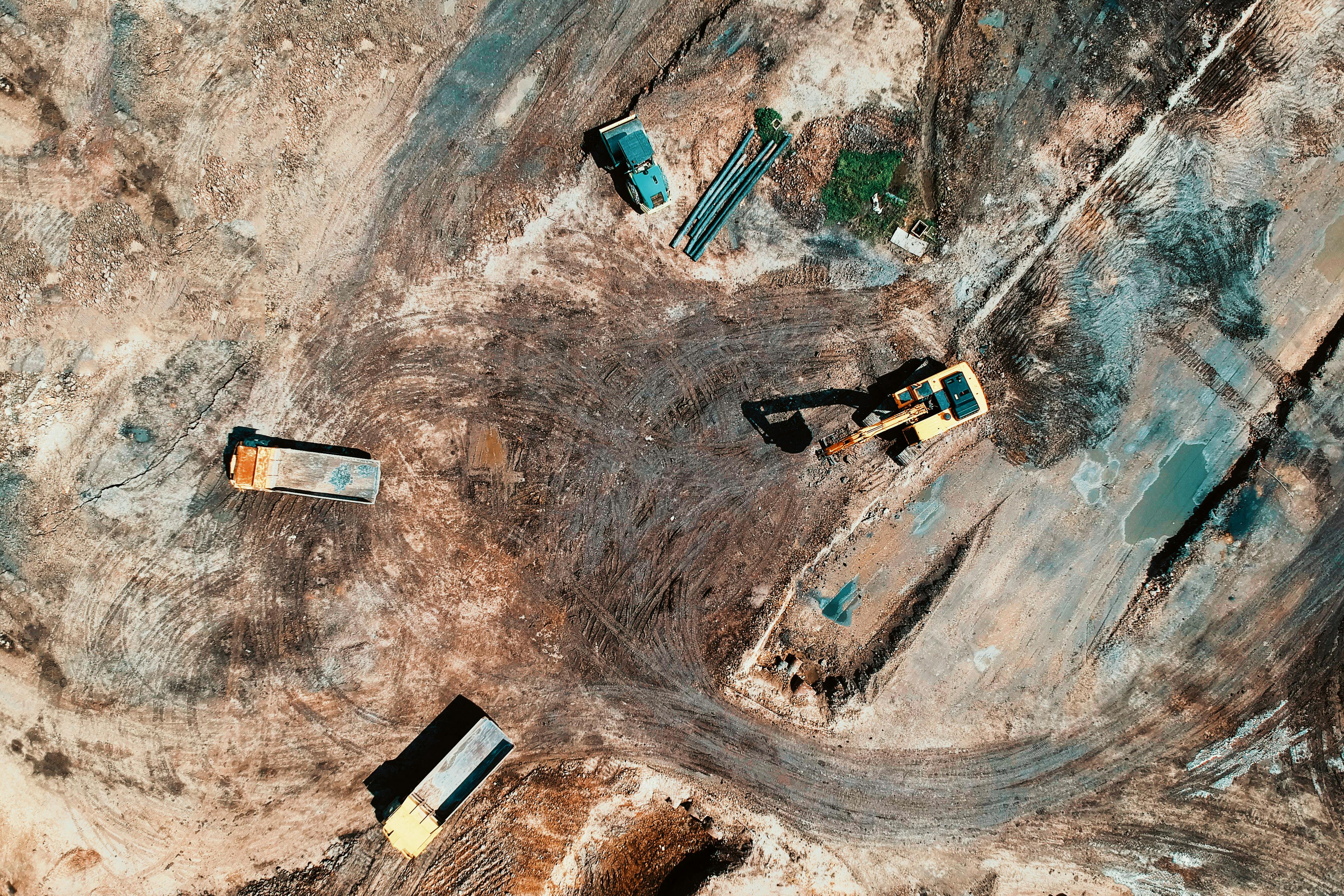 aerial view photography of utility vehicles on brown soil