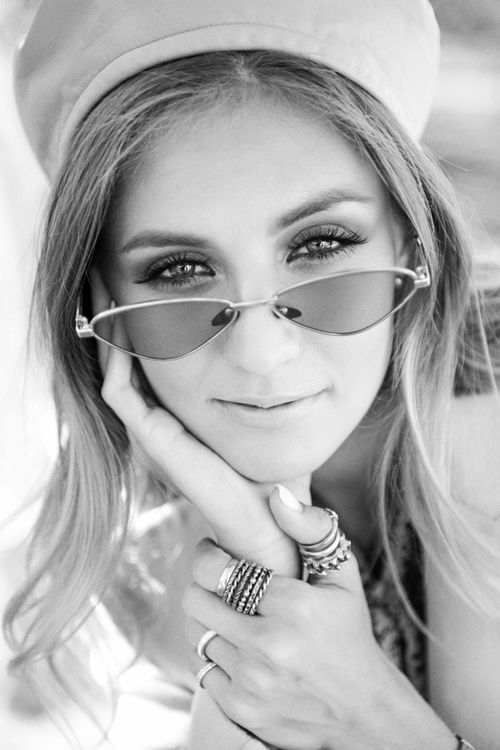 Free Black and white portrait of a young woman wearing sunglasses and a bonnet. Stock Photo