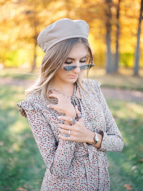 Free Elegant woman in flowery dress and hat, enjoying a sunny autumn day in the park. Stock Photo