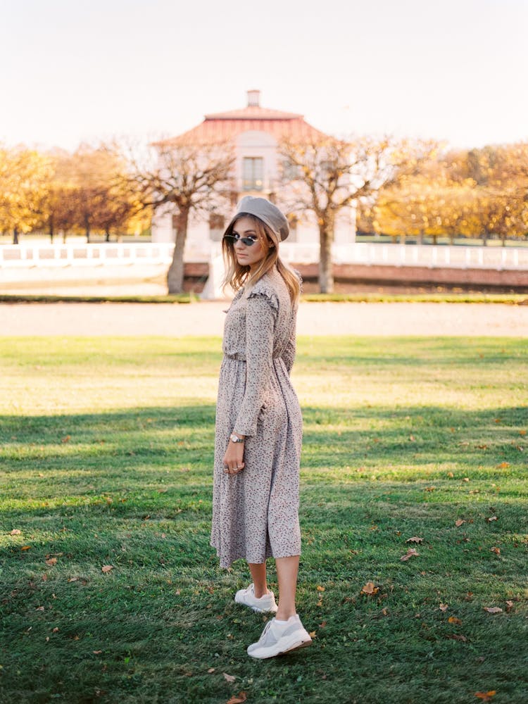 Woman Fashion Model Posing In Shade Of Tree In Park