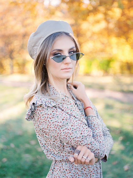Young Woman Posing in Photo-Chrome Eyeglasses in Park · Free Stock Photo