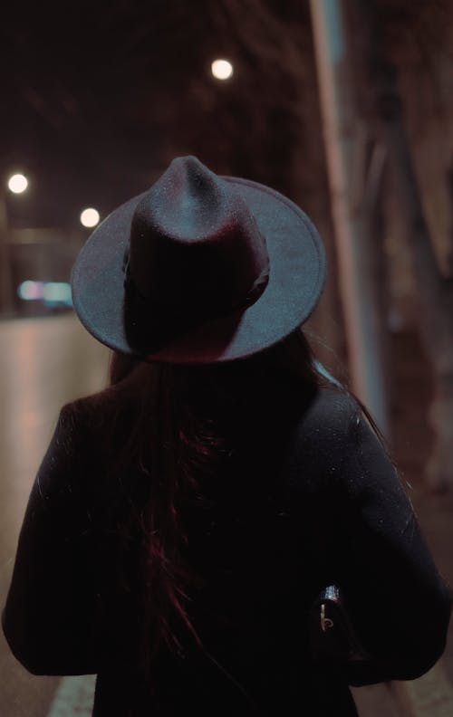 Woman in Hat at Night