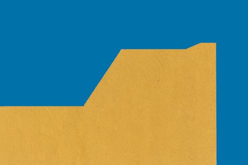 Free A minimalistic photo showcasing a geometric pattern with blue and yellow textures. Stock Photo