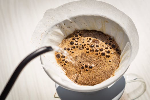 Close-up view of fresh coffee brew preparation using a drip filter method.