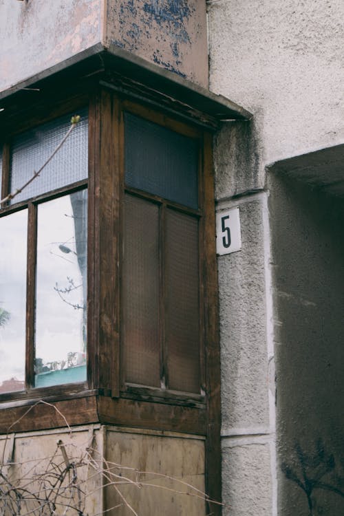 A Number Posted Outside a Concrete Wall of a Family House