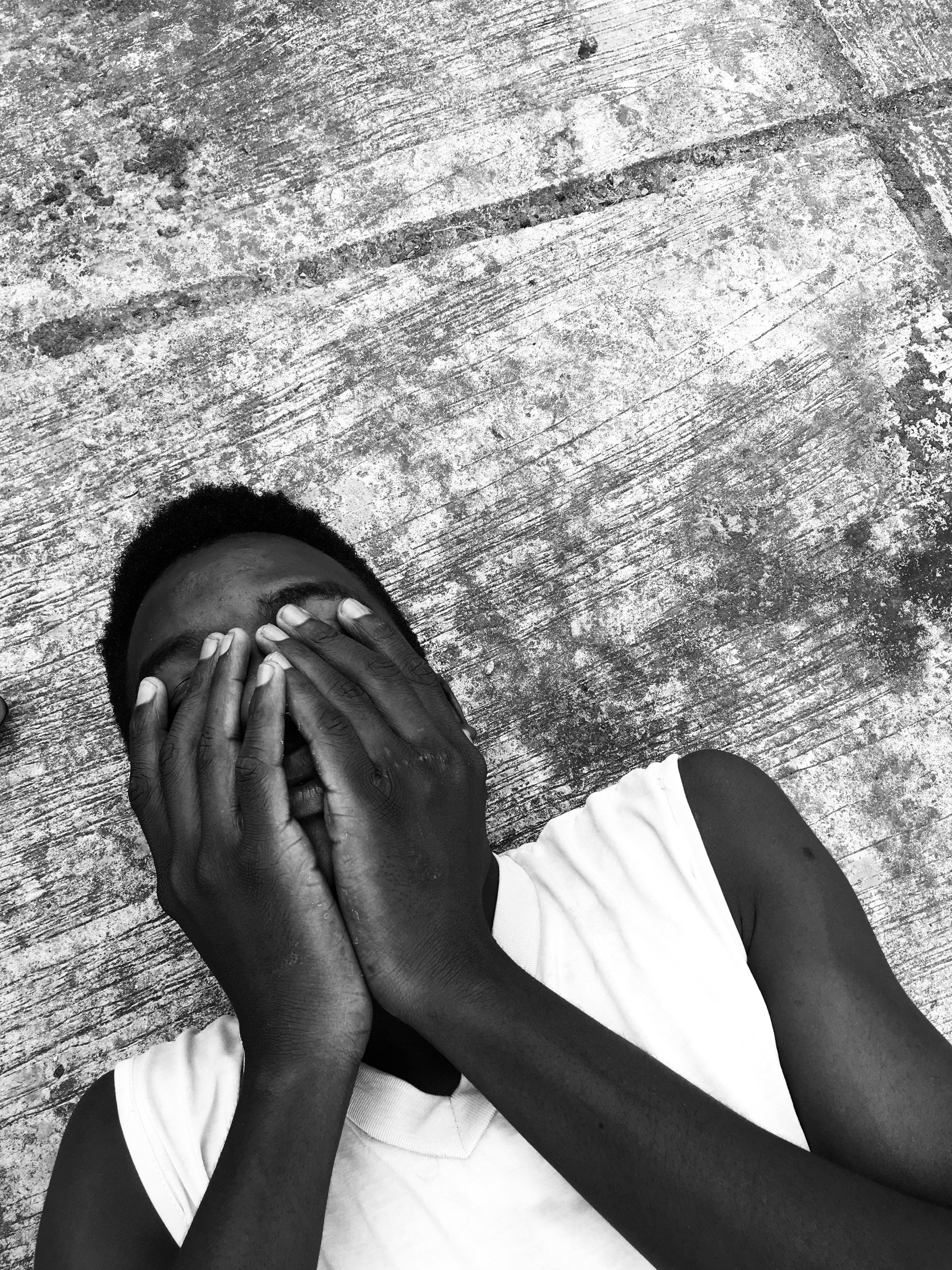 Black and White Photo of a Man Covering his Face · Free Stock Photo