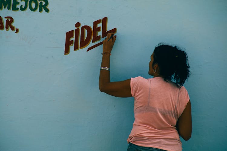 Woman Painting On White Wall