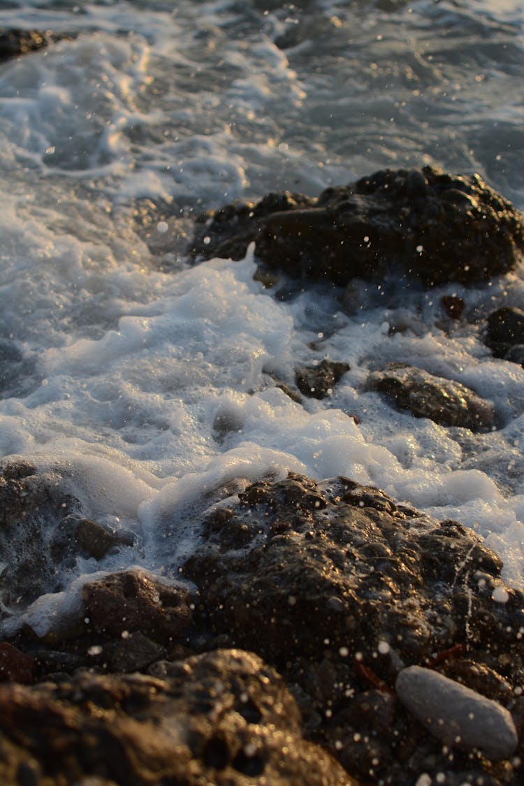 Photograph Of Seafoam On Rocks