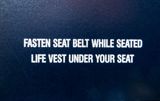 Fasten Seat Belt While Seated Life Vest Under Your Seat Text Overlay