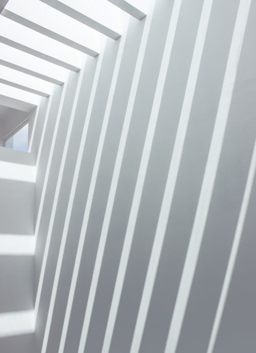 Free Abstract view of geometric shadows on modern white walls creating a unique pattern. Stock Photo