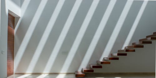 Photograph of Wooden Stairs Near a Wooden Door