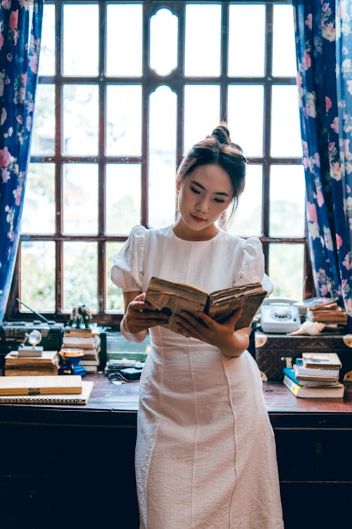 Gratis stockfoto met Aziatische vrouw, binnen, boek