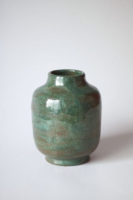 Green glazed stoneware vase on a pale backdrop — photo by Andreea Ch on Pexels