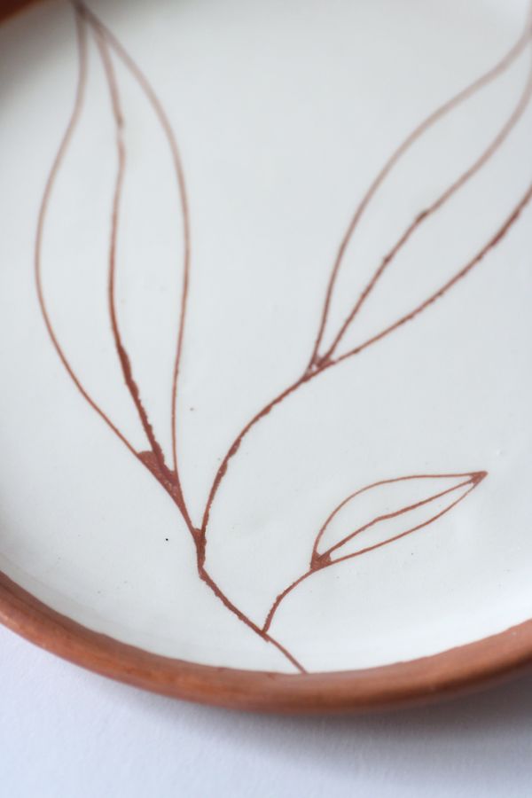 Handmade ceramic plate with a painted leaf motif, photo by Andreea Ch on Pexels