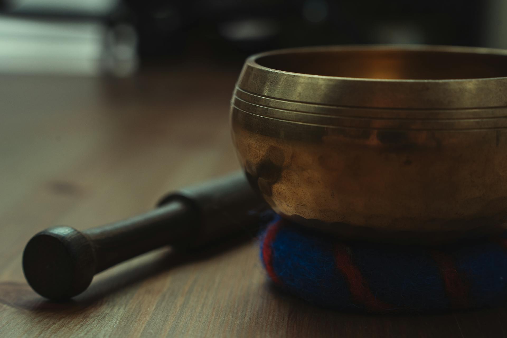 Tibetan Singing Bowl on Brown Wooden Table Top