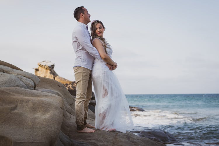 Man In A White Dress Shirt Hugging A Woman