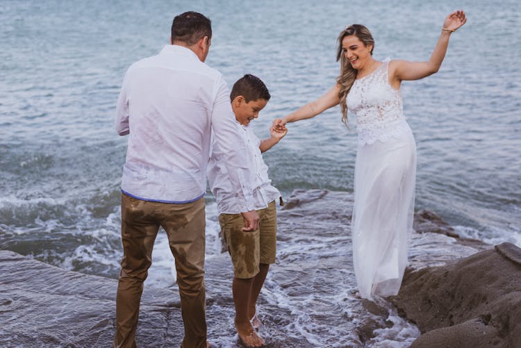 A Family Bonding At The Beach While Holding Hands