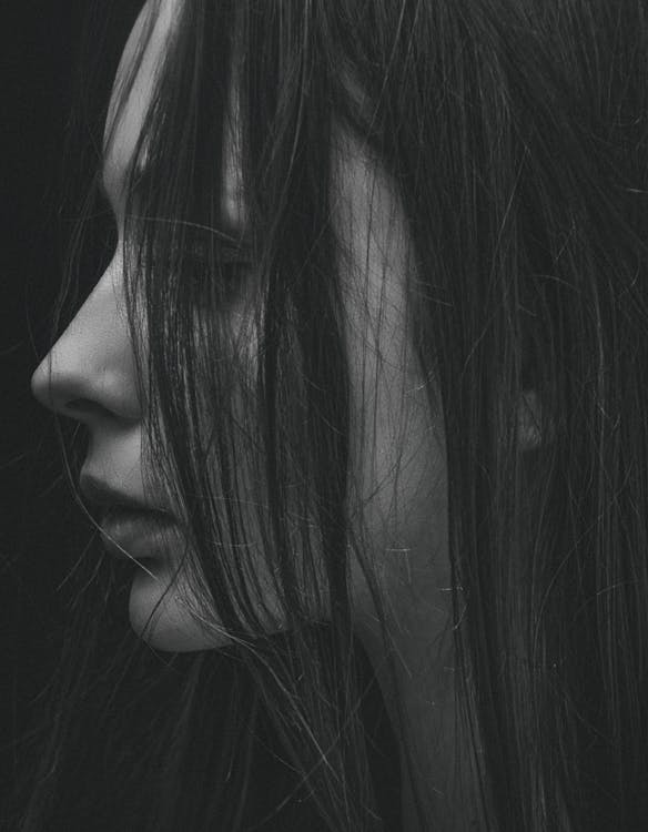 Grayscale Photo of hair partially covering girl's face
