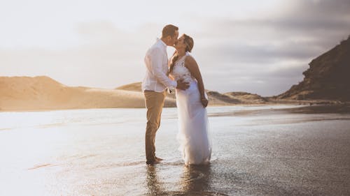 Photograph of a Couple Kissing at the Beach