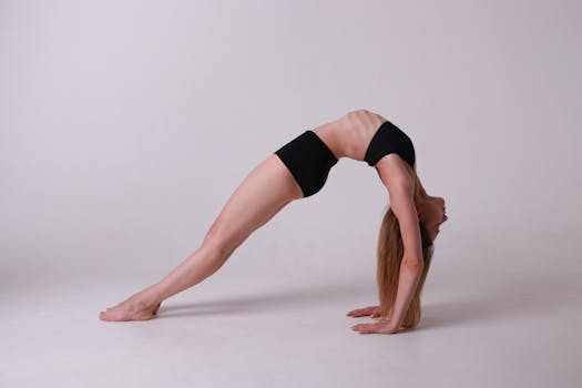 Woman in a bridge pose practicing yoga indoors, showcasing exercise and flexibility.