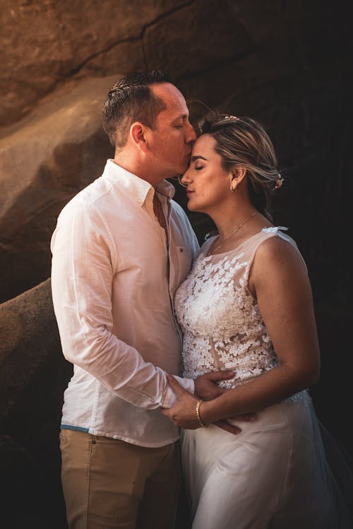 Man Kissing his Bride on the Forehead