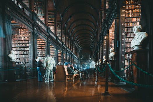 A timeless library with towering bookshelves, statues, and blurred people moving through.
