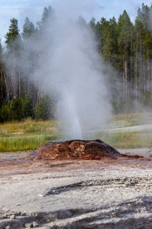 Free Captivating eruption of a geyser amidst Yellowstone's stunning natural landscape. Stock Photo