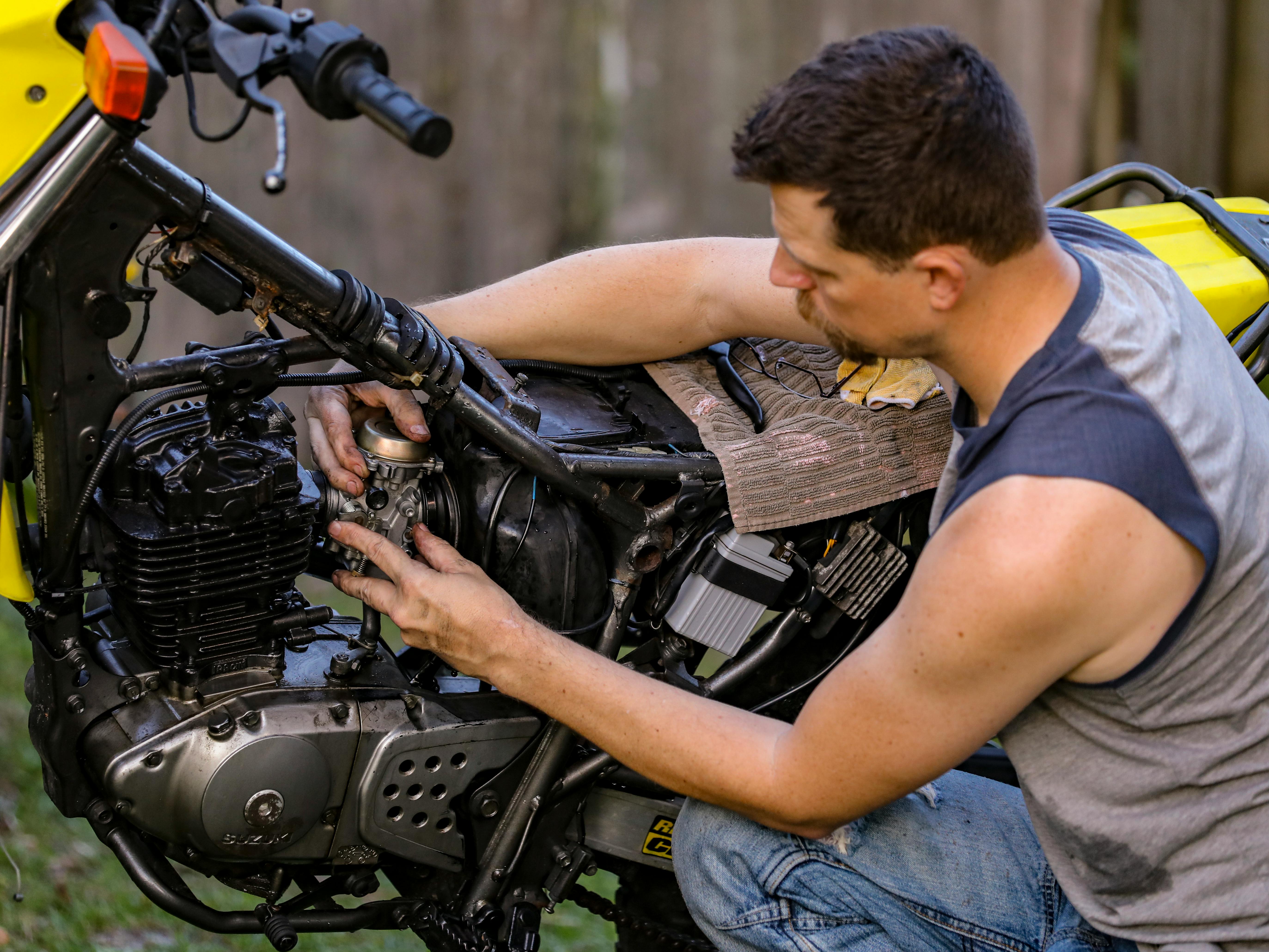 A Man Fixing a Motorcycle · Free Stock Photo