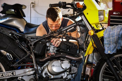 A Man Fixing a Motorcycle