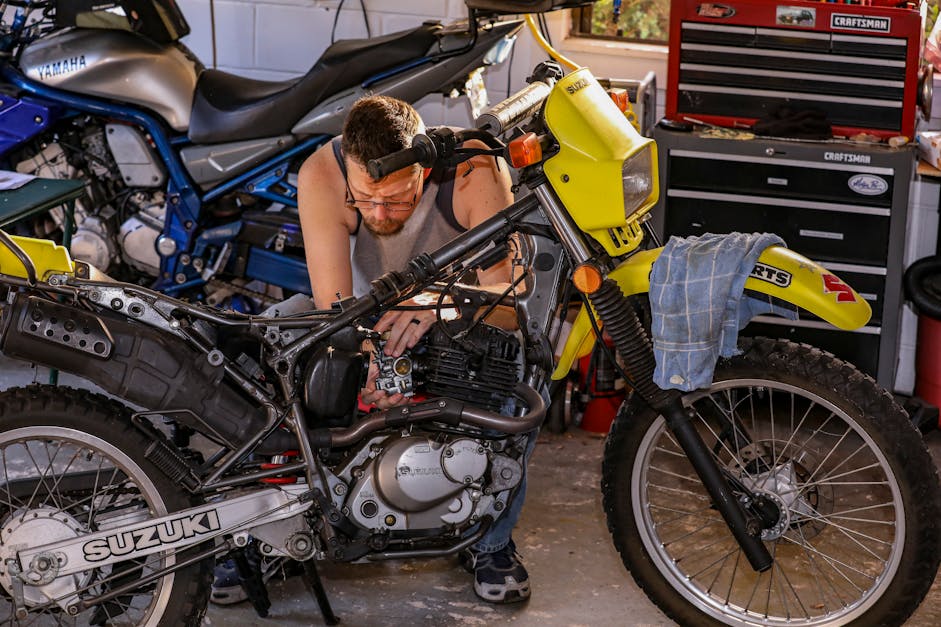 A Man Fixing a Motorcycle · Free Stock Photo