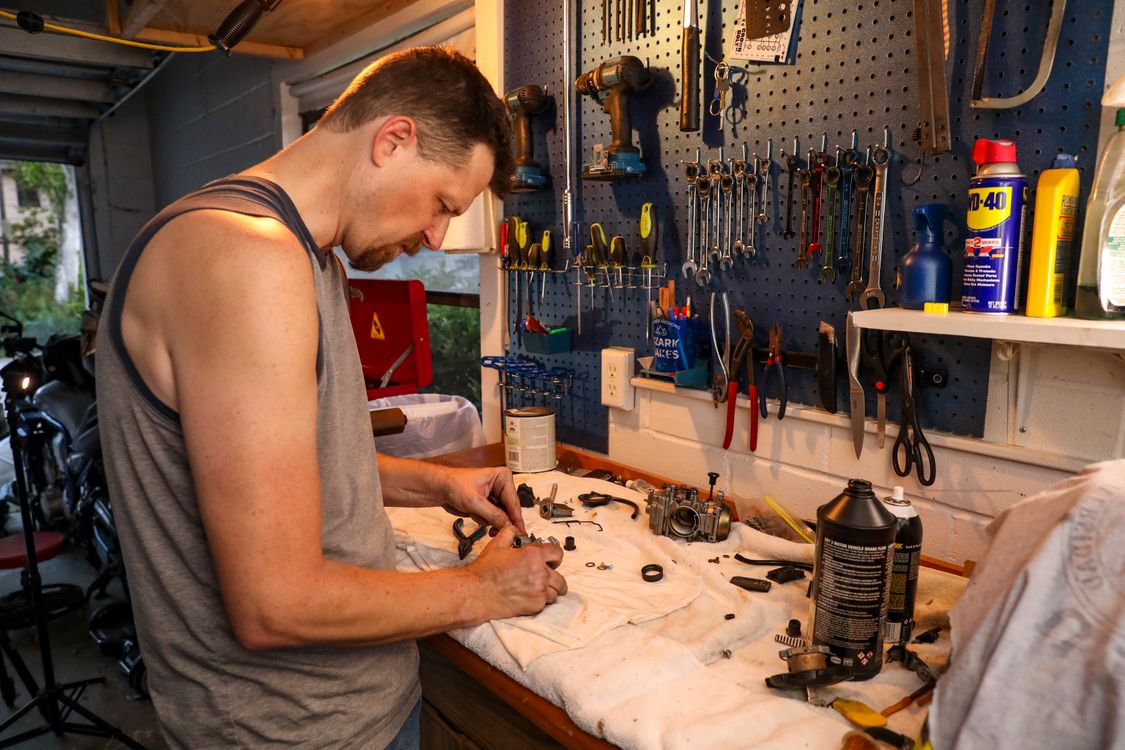 Free Man Working in a Garage Stock Photo