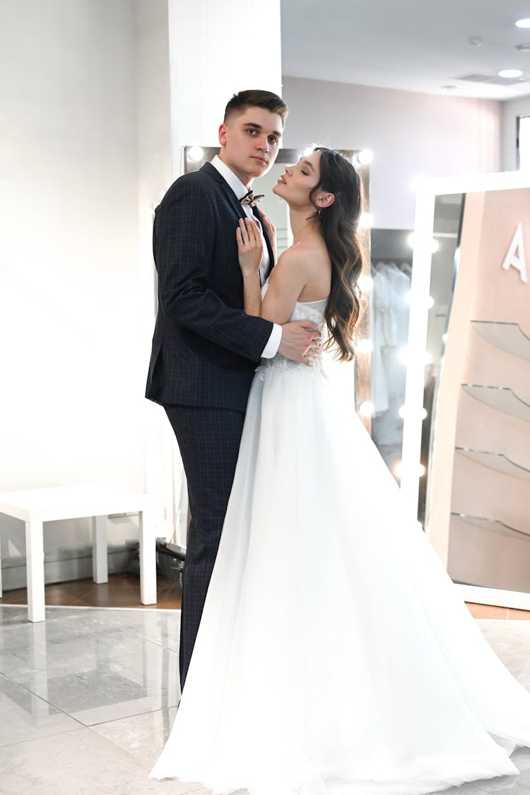 A Groom In A Suit And A Bride In A Gown