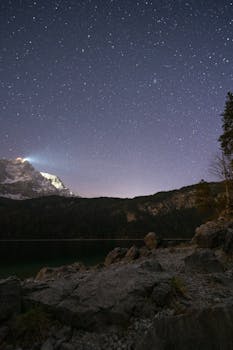 Captivating star-filled sky over rugged mountain terrain at night.