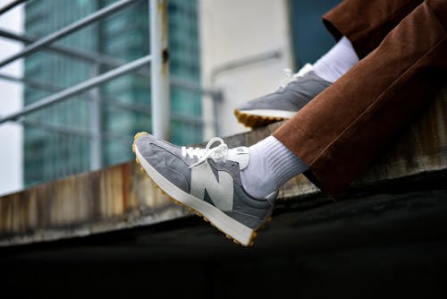 Person Wearing Gray Sneakers