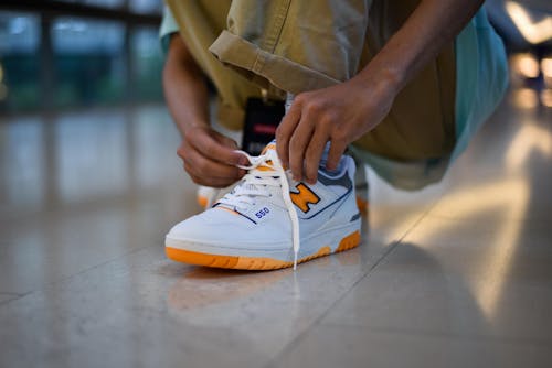 Free Close-Up Shot of a Person Tying Shoes Stock Photo