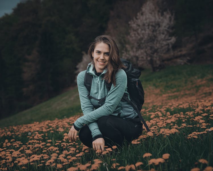 Girl With Backpack Posing In Dandelions