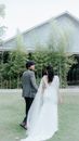Woman in Bridal Gown Walking Beside a Man