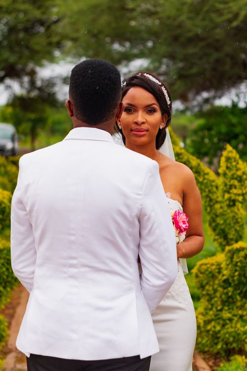 Free Bride and groom in a beautiful garden setting in Palapye, Botswana. Stock Photo